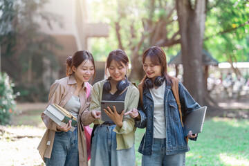 university students using a digital tablet while walking to next class
