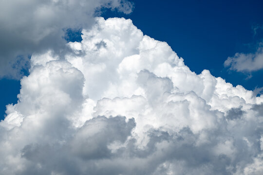 Billowing cumulus clouds against a blue sky