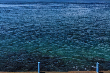 A view of the clear, blue sea taken from a bird's eye view. 