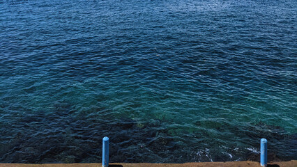A view of the clear, blue sea taken from a bird's eye view. 