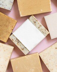 Beige and brown handmade soap bars on light pink top view, soap packaging mockup