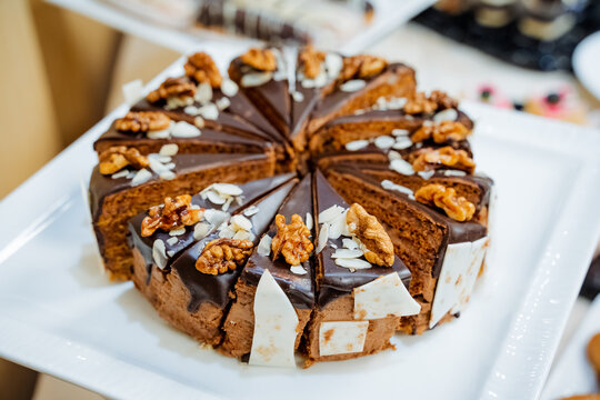 Chocolate tora with nuts, large cake cut into small pieces, sweet treat, serving for the holiday.