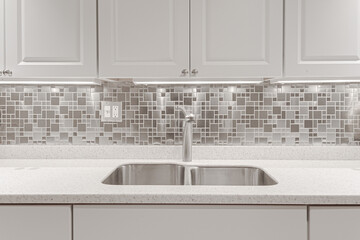 Modern White Kitchen Interior with Steel Mosaic Backsplash, Under-Cabinet Lighting, and Sleek...