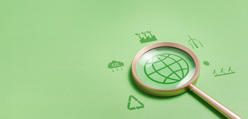 Magnifying glass with reduce CO2 emissions carbon global symbol on green background for climate change to limit global warming and sustainable development and green business concept