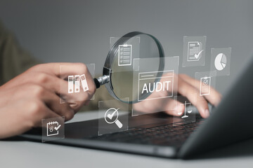 Businessman using laptop computer to audit and evaluate corporate financial statements for Audit...