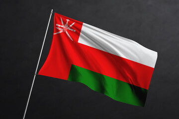 3D Waving flag design. Oman National flag on black background.