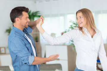 romantic couple dancing in the lving room