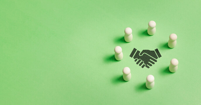 Human shaped wooden doll with handshaking icon for business team building concept. employment headhunting, candidate, human resources management and teamwork