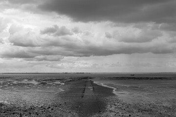 Black and white image of the pathway to the Thames at Westcliff, Essex, England, United Kingdom