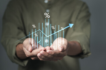 Businessman holding growth graph with percent symbol for increase in interest rates and dividends,...