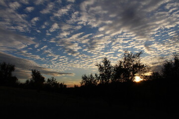 A sunset with clouds in the sky