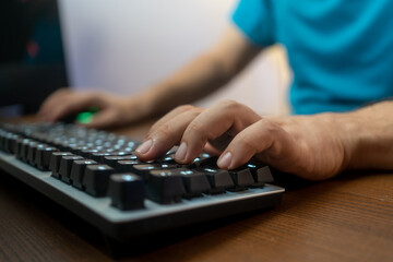 Hacker uses keyboard, shakes buttons with fingers to crack password. Internet security concept,...