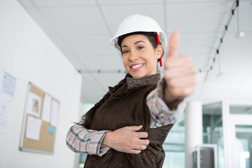 portrait of beautiful female architect gesturing thumbs up