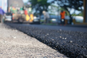 Blurred image of paving surface with heavy machinery