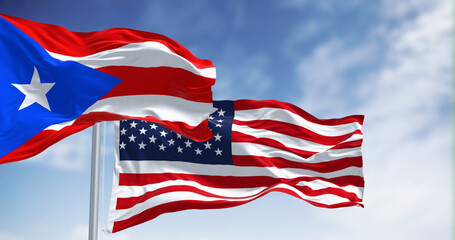 Flag of Puerto Rico waving with the United States flag on a clear day