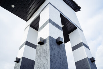 Arch lighting on the street, small black lamps are mounted to the wall, modern lighting halogen lamp.