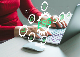 ESG icons pop up on the computer screen in business investment strategy concept.ESG environmental social governance policy for modish business to set a standard to achieve high ESG score.
