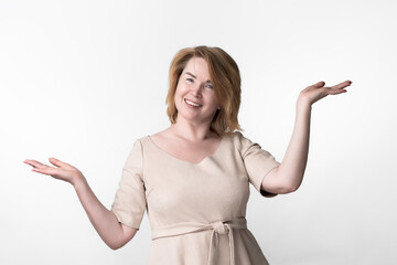 Happiness woman gesticulating raised hands, palms up, depicting scales and looking at camera....