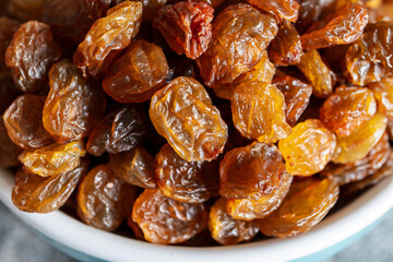 Close up of dark raisins - dried grapes, vegetarian nutrition, healthy food, nutrition for heart muscle