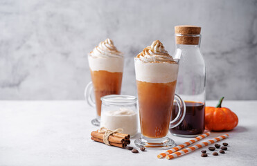 Pumpkin spice latte with whipped cream and cinnamon in a glass