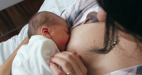 Newborn baby breastfeeding after birth, first day of life