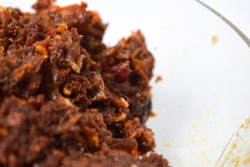 Close up Sambal ikan teri or anchovy chili fried is indoneisan side food, Indonesian chili sauce. Sambal ikan teri shoot on White Background.