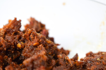 Close up Sambal ikan teri or anchovy chili fried is indoneisan side food, Indonesian chili sauce. Sambal ikan teri shoot on White Background.