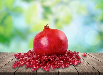 Fresh ripe tasty sweet pomegranate on desk