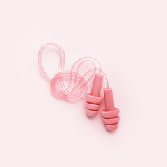 Reusable silicone earplugs pink color, for swim, sleep, rest. Soft, flexible ear plug on cord against noise, protect hear, close up object on colored background, monochrome top view, minimal style