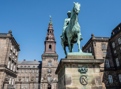 Christiansborgs Palace, home of the Danish Parliament, with statue of King Frederik VII, Copenhagen, Denmark