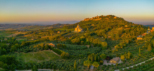 Elevated view of vineyards, olive groves and Montepulciano at sunset, Montepulciano, Tuscany