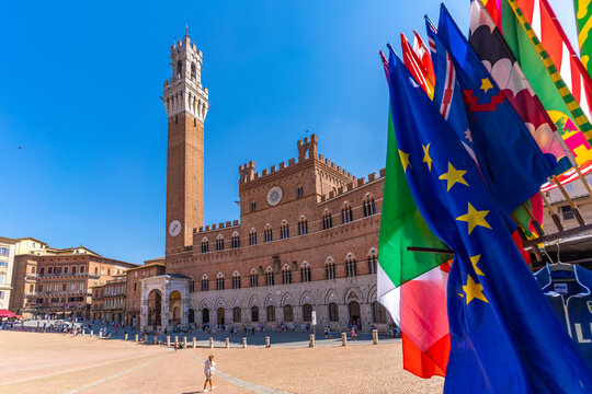 View of flags and Palazzo Pubblico in Piazza del Campo, UNESCO World Heritage Site, Siena, Tuscany