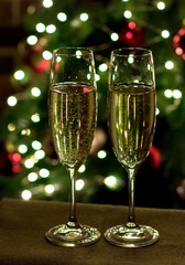New Year's Eve and Christmas celebrations. Champagne on the background of a Christmas tree