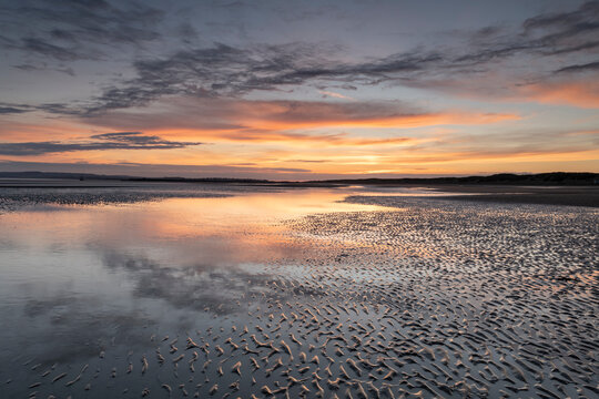 Beach at low tide at sunset, Camber Sands, East Sussex, England