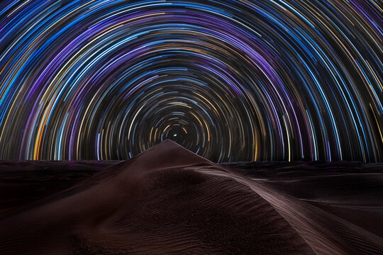 Star trail over the sand dunes of Rub al Khali desert, Oman, Middle East