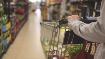 girl buying grocery with the cart in the supermarket