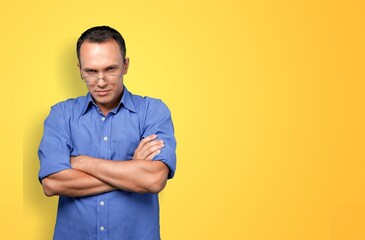 Young happy man standing over color background