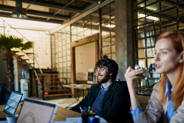 Smiling young businessman sitting during a meeting in the office