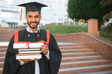 education, graduation and people concept - happy Indian Male graduate student.
