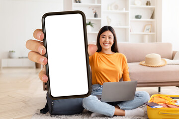 Asian woman traveler showing phone with blank screen