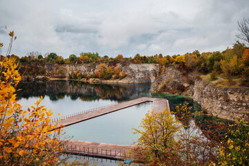 Fototapeta na wymiar Aerial panoramic view of popular touristic location Zakrzówek Quarry, Krakow. Floating swimming pool. Cloudy autumn day