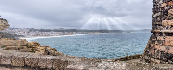 View of bay with Light rays and stormy skies