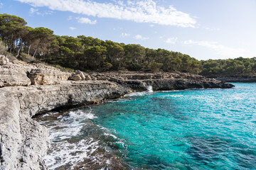 Landscape with turquoise, azure sea water on a sunny day, Cala Mondrago, Majorca island, Spain