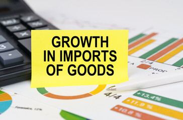 Obraz premium On business reports there is a calculator and a sign with the inscription - growth in imports of goods