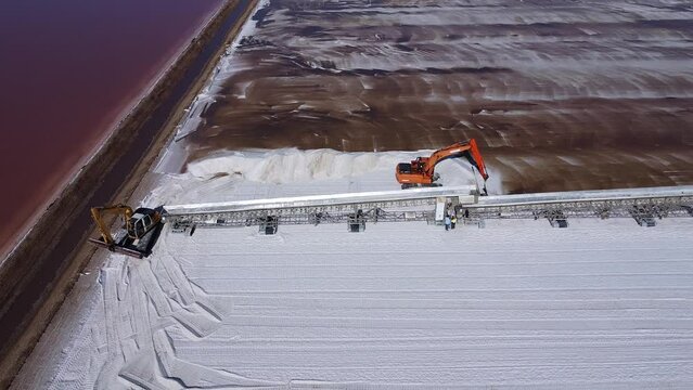 Aerial drone view of Salt production in the evaporators of sea salt in nature reserve Marismas del Odiel. Traditional Sea salt production produced by the evaporation of seawater.