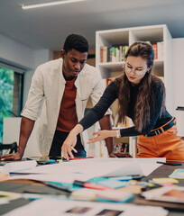 Fototapeta premium Young colleagues working with documents in office