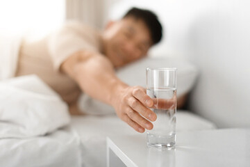 Man drinking water after waking up in the morning