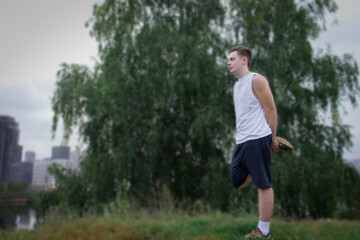 Young man wearing sportswear practicing yoga, doing balance exercise