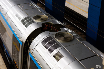Passenger train carriages on the railway station platform seen from above. View of the air...