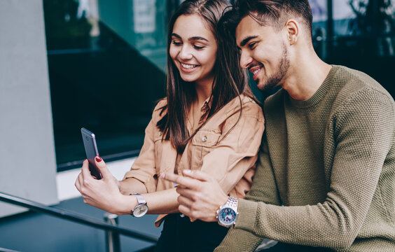 Smiling romantic couple posing for selfie on smartphone camera spending free time outdoors